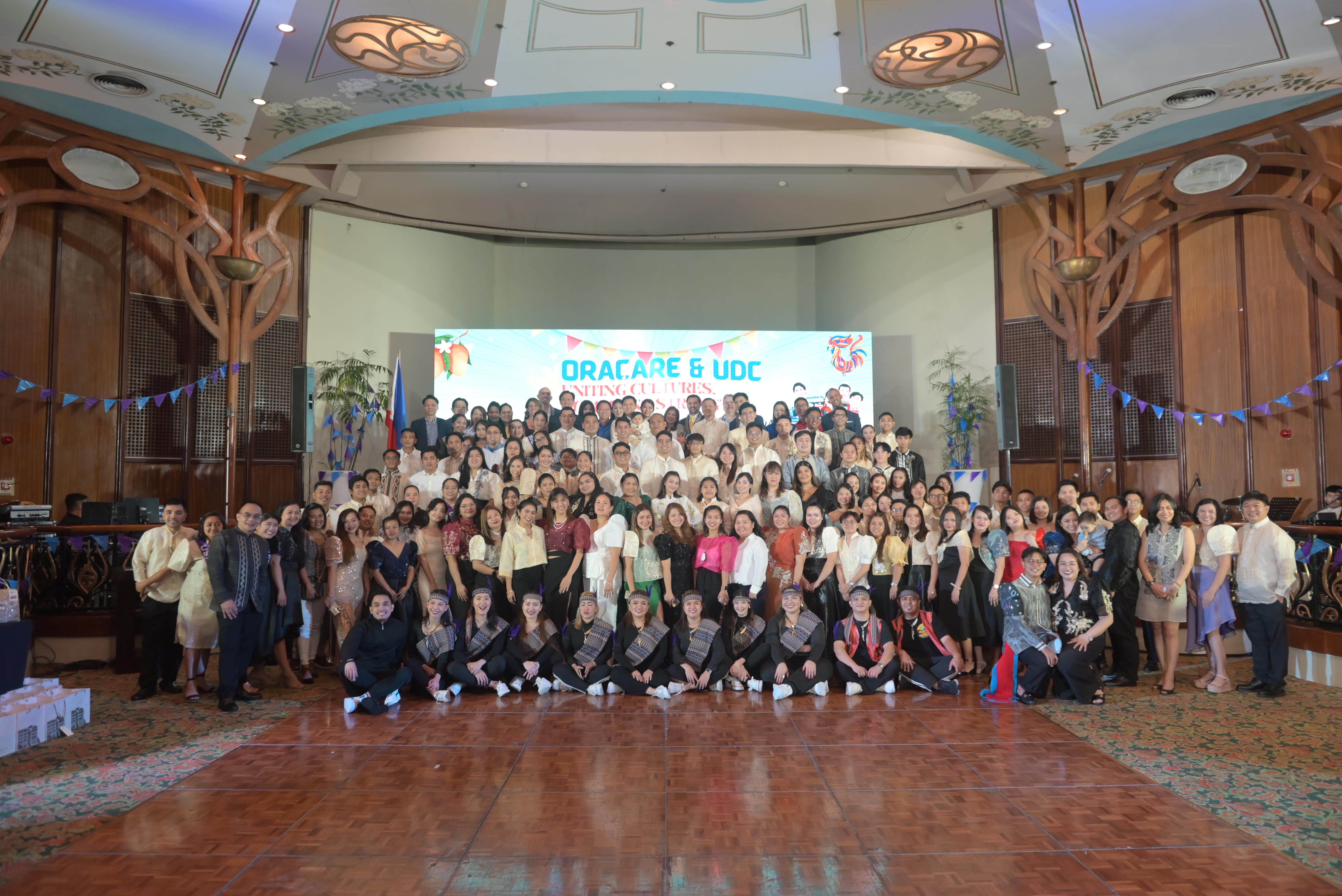 The management and staff of the extended Oracare family coming together to unite cultures and combine strengths at the Oracare-UDC celebration event on 27 October 2023 in Manila, the Philippines.