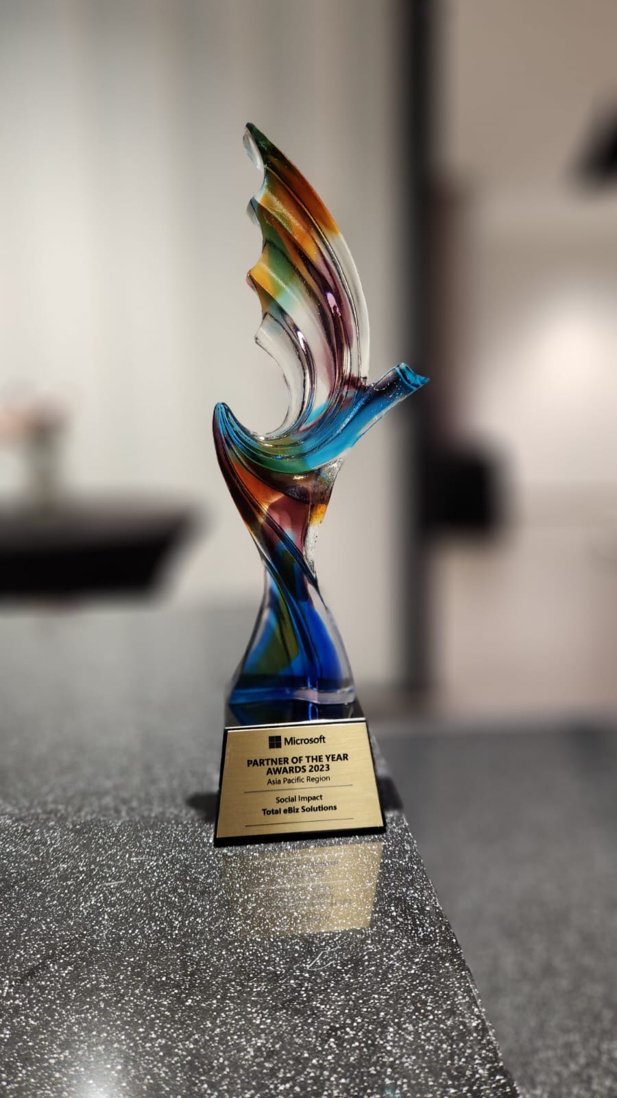The trophy awarded to Total eBiz Solutions, symbolizing their achievement as the Microsoft Asia Pacific Region Partner of the Year 2023 for Social Impact.